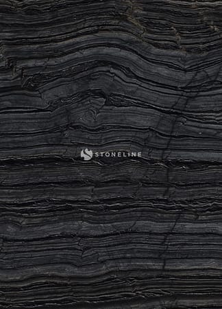 Close-up of dark layered rock sediment.