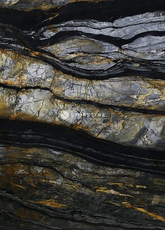 Close-up of textured, multicolored rock surface