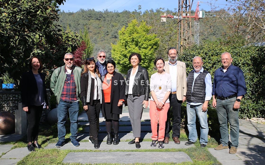 Group of people outdoors in a sunny garden.