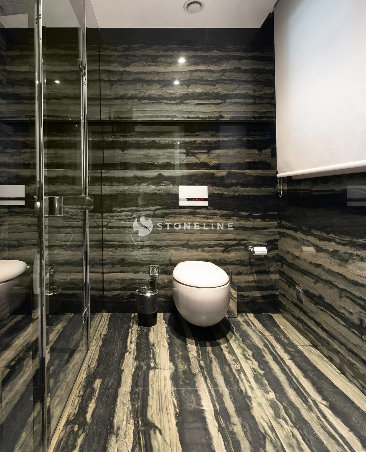 Modern bathroom with marble walls and floor.