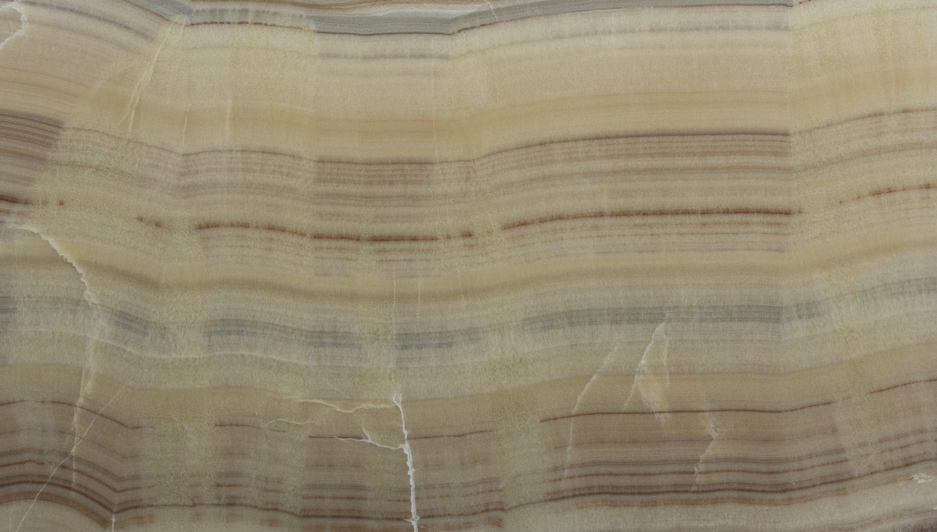 Close-up of beige onyx stone texture and patterns.