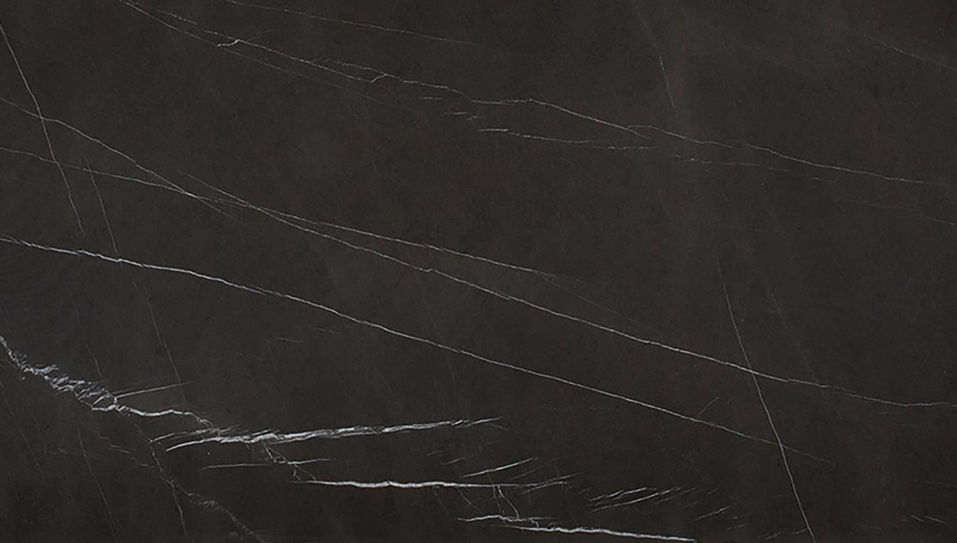 Dark marble surface with fine white veins.