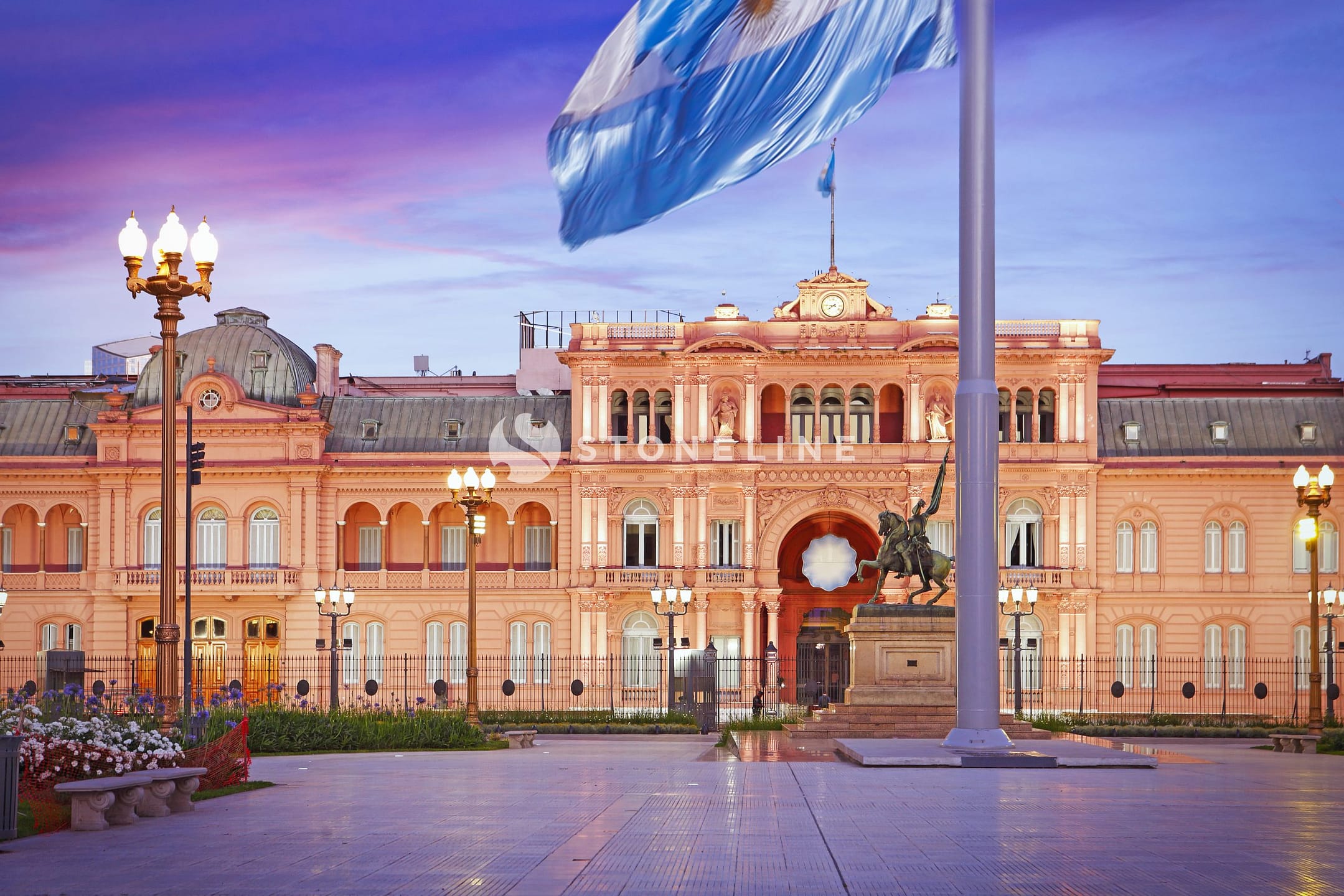 Casa Rosada with waving flag at sunset