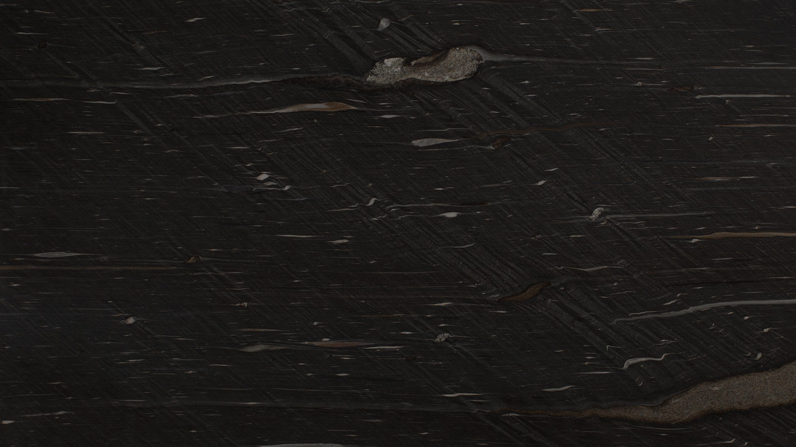 Dark textured stone surface, close-up view.