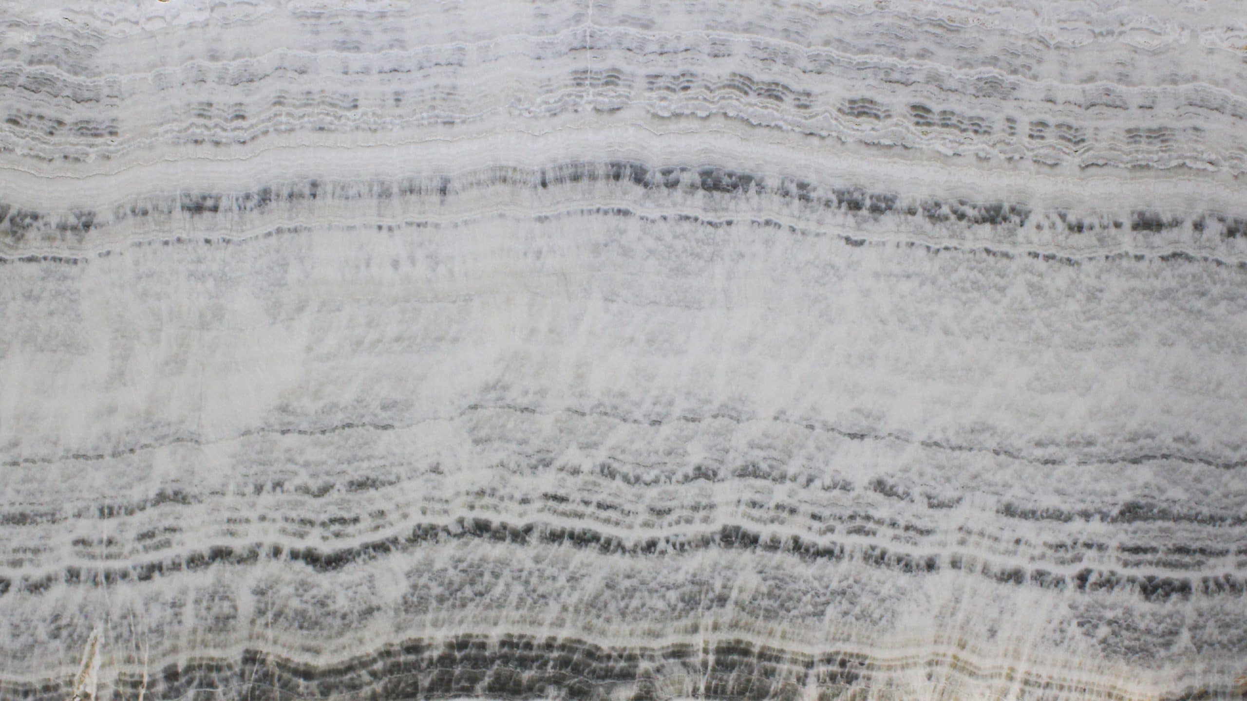Close-up of textured gray and white marble surface.