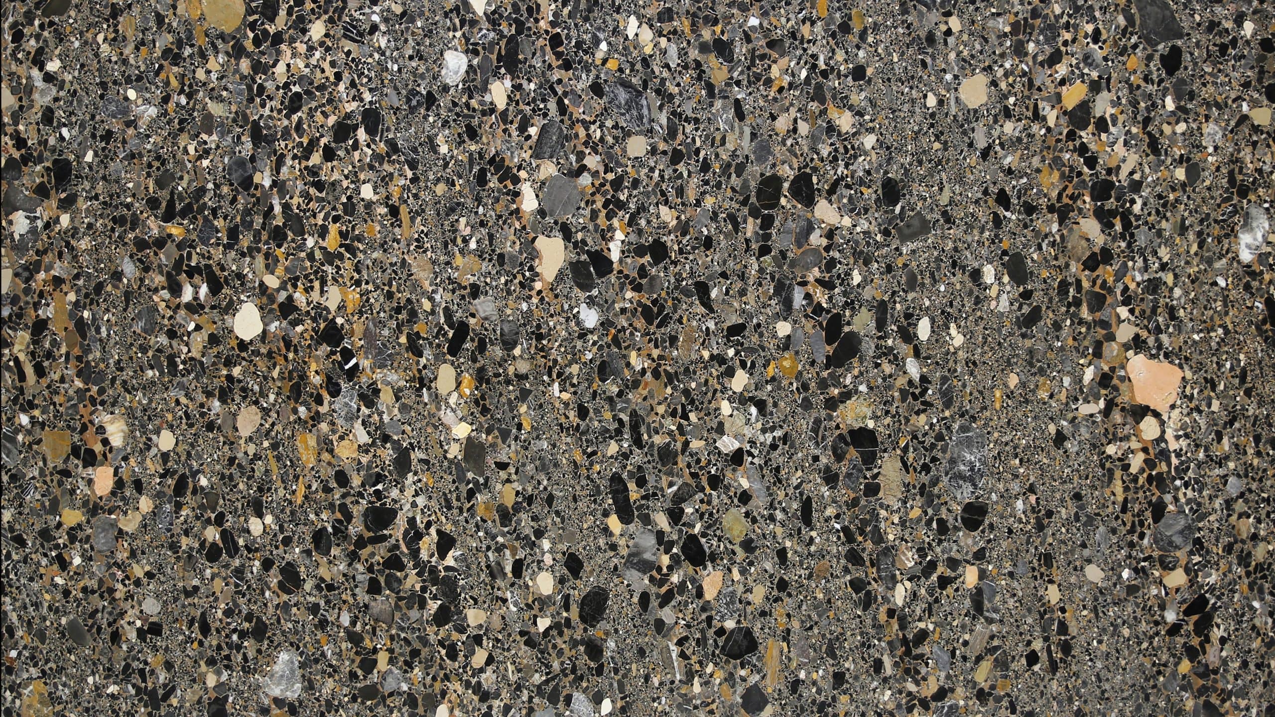 Close-up of textured stone surface in various colors.