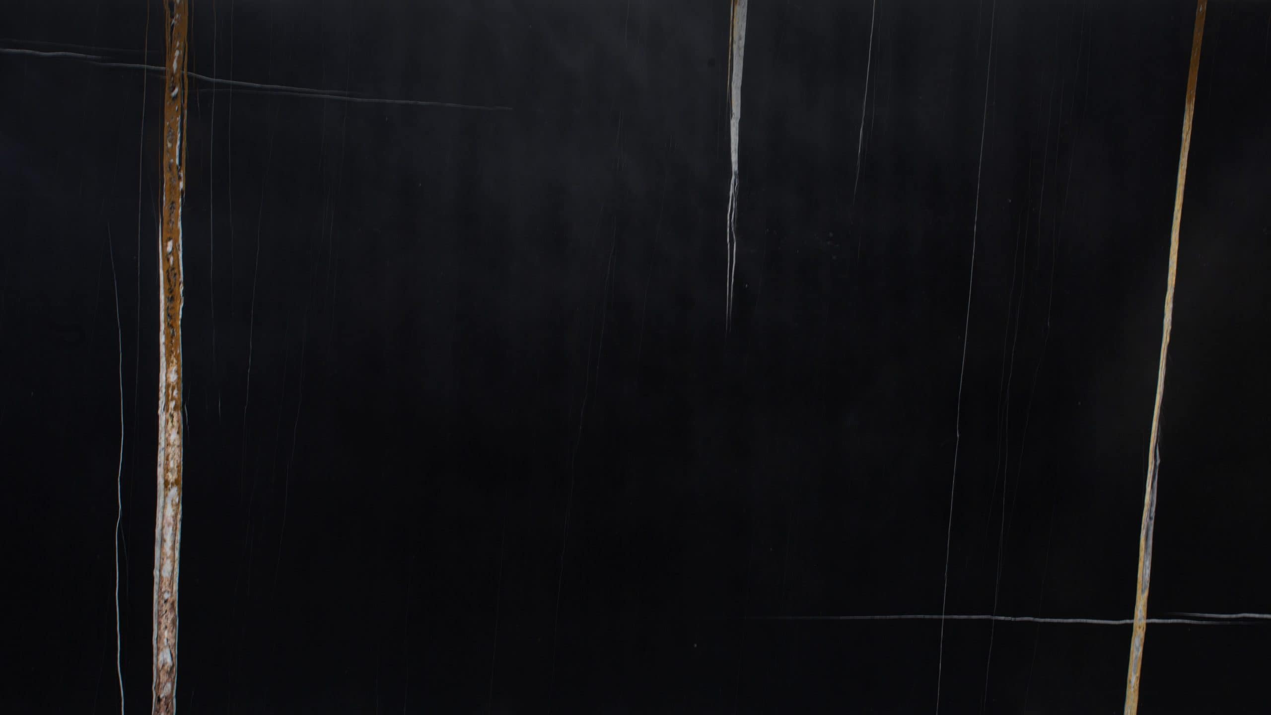 Abstract black surface with vertical brown lines