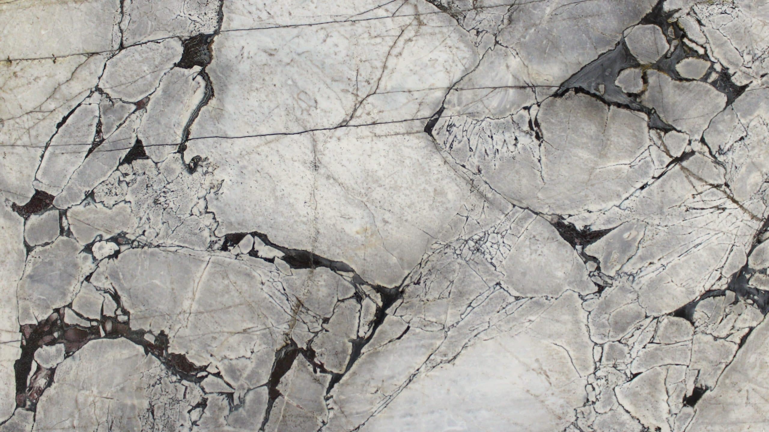 Close-up of cracked, textured gray marble.