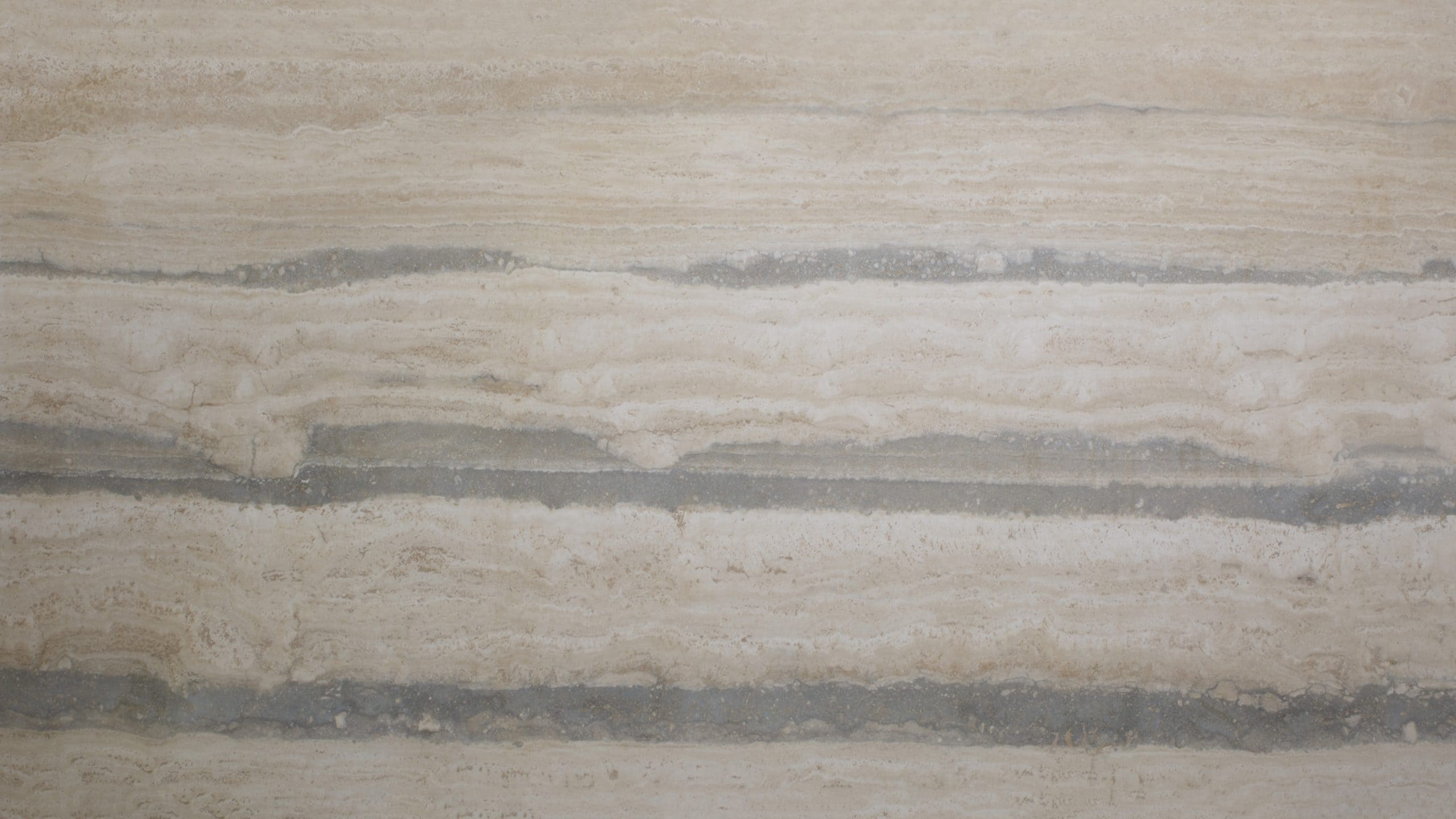 Beige marble surface with horizontal striations.