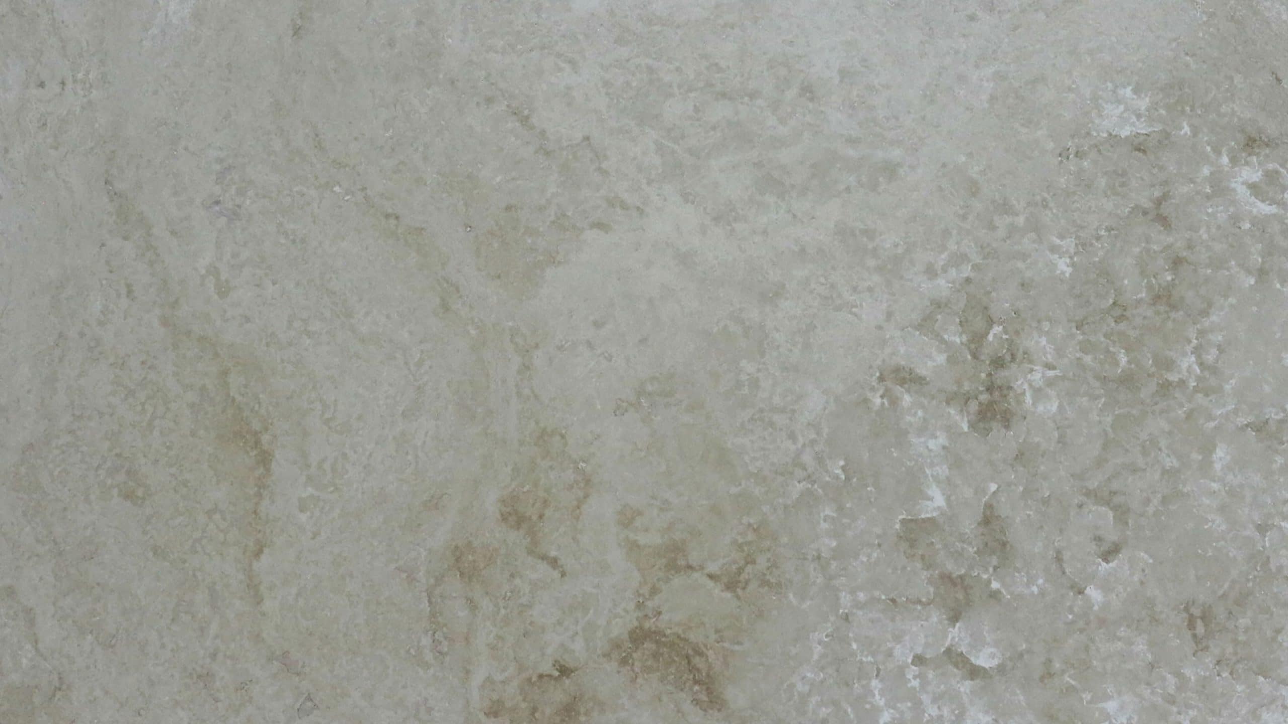 Textured beige marble surface detail.