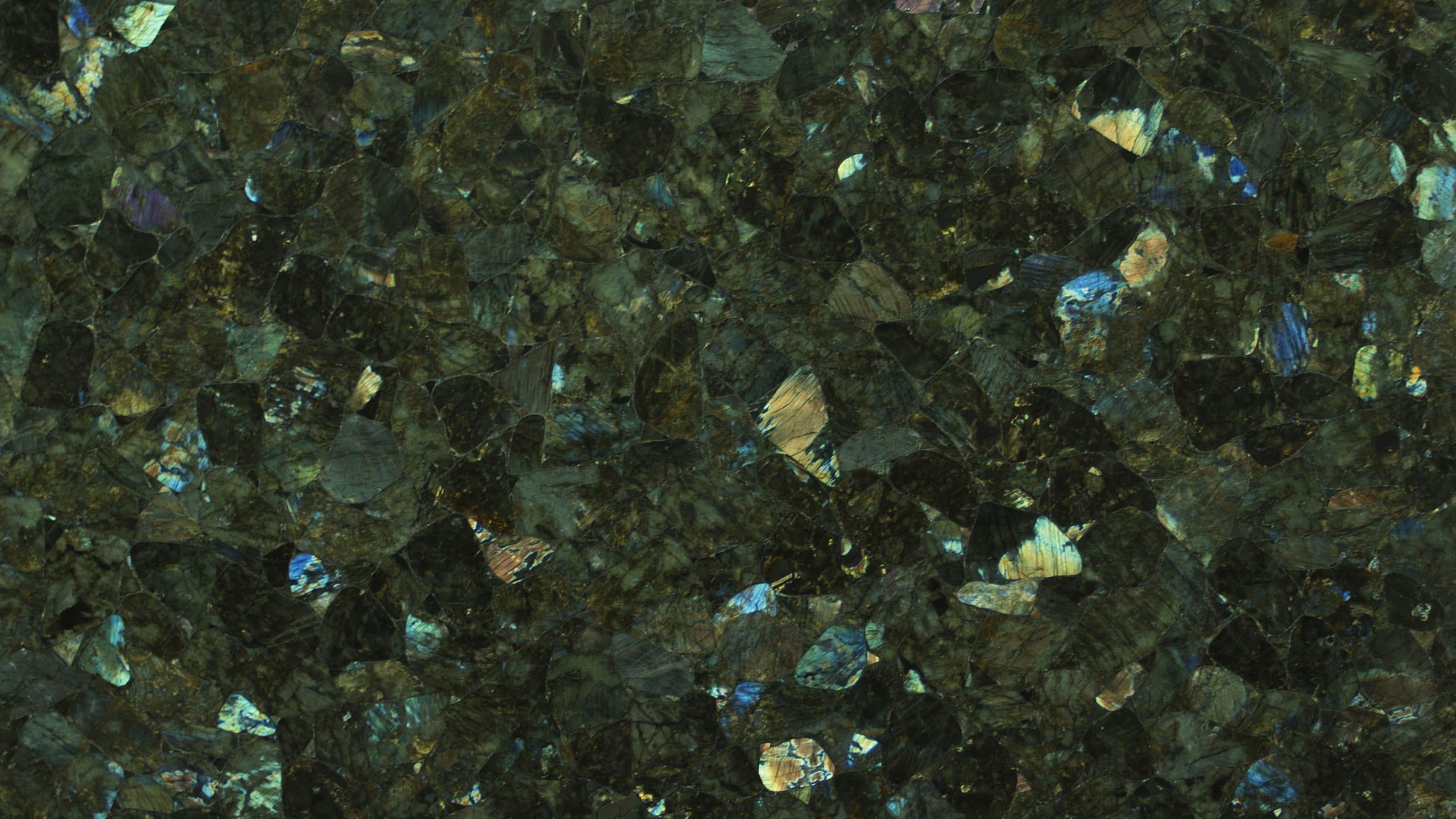 Close-up of dark granite texture with iridescent flecks.