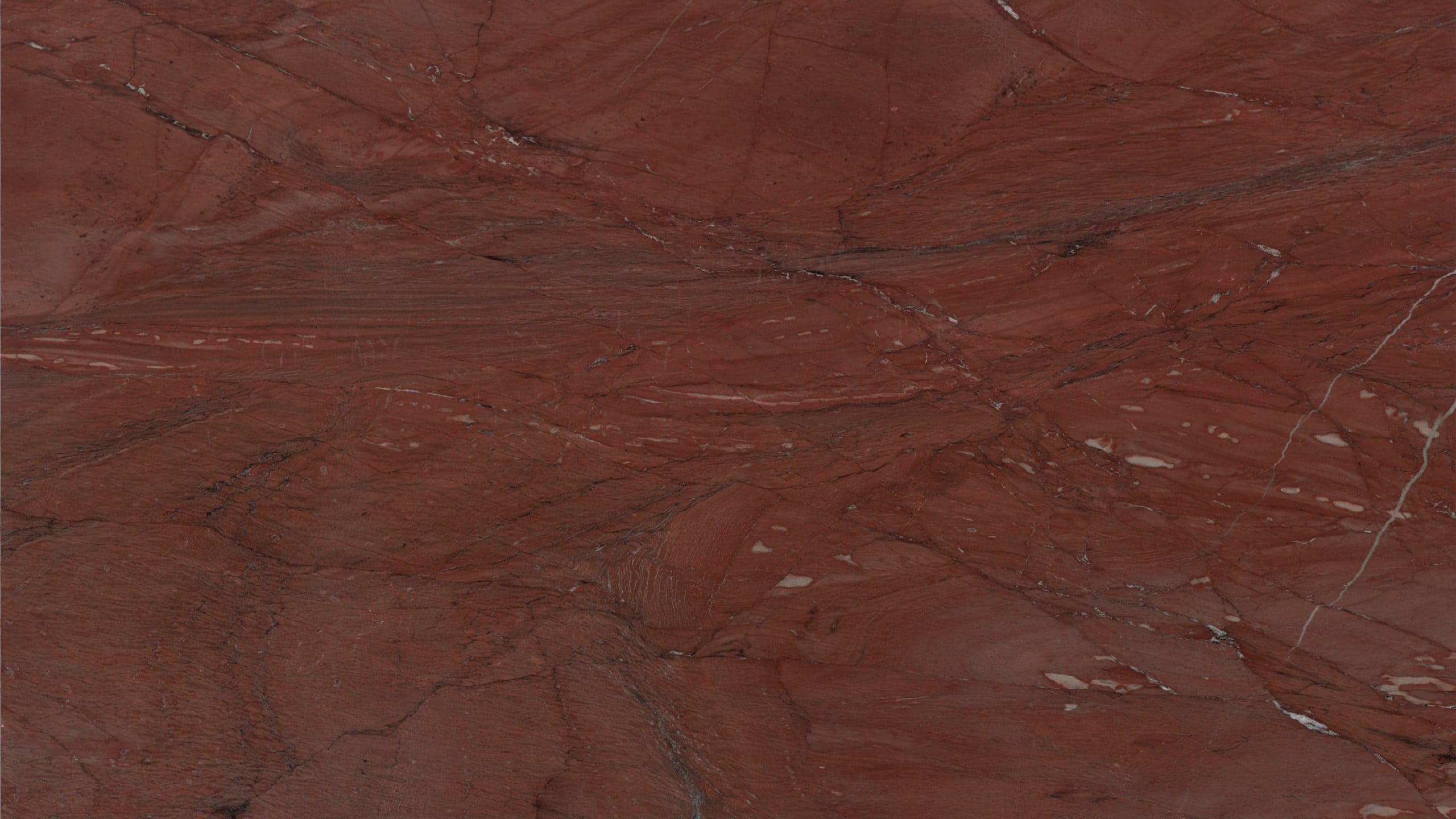 Red marble texture with natural patterns and veins.