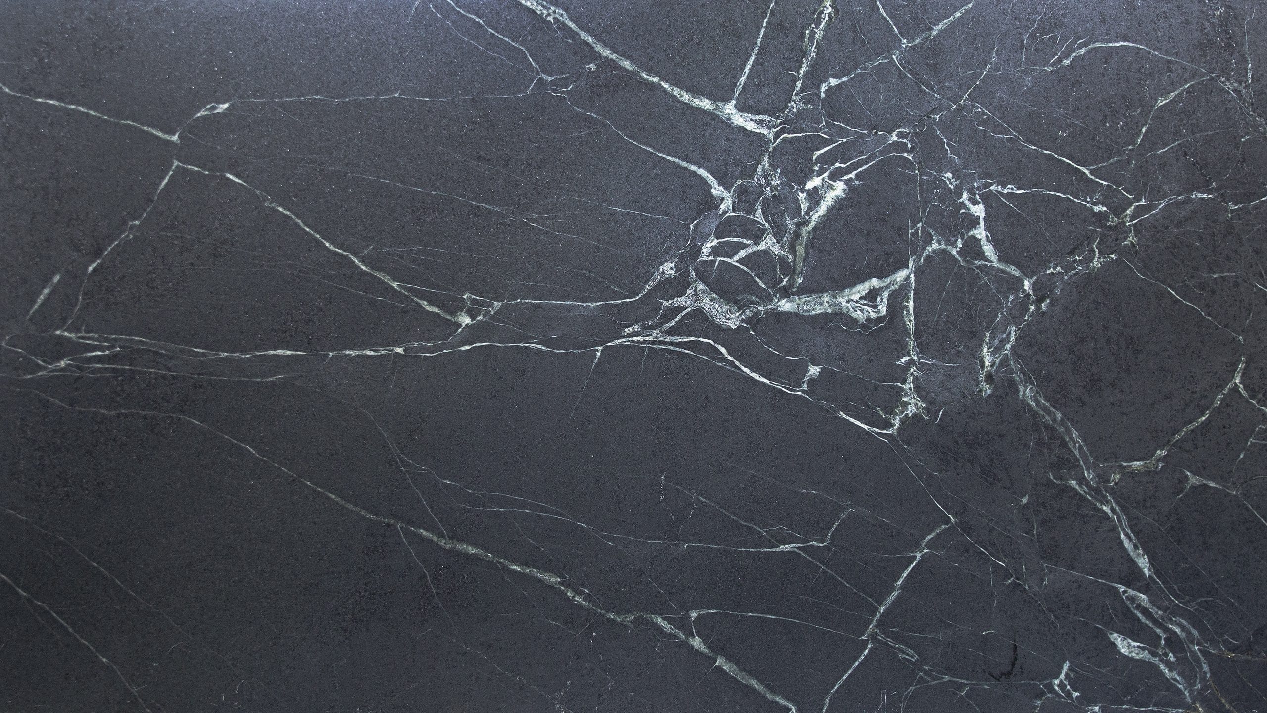Dark gray marble texture with white veins.