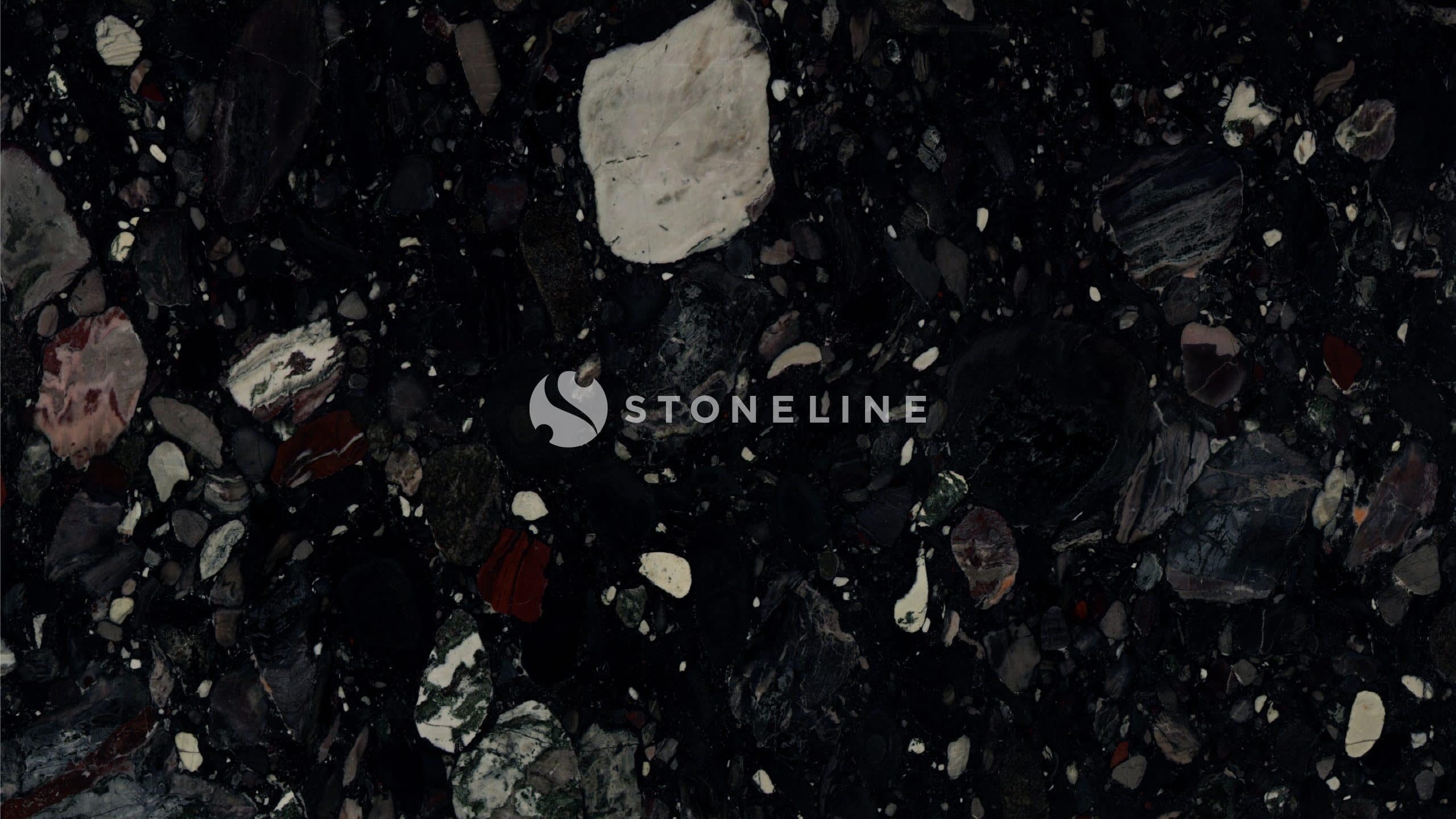 Dark textured rock surface with various stones.