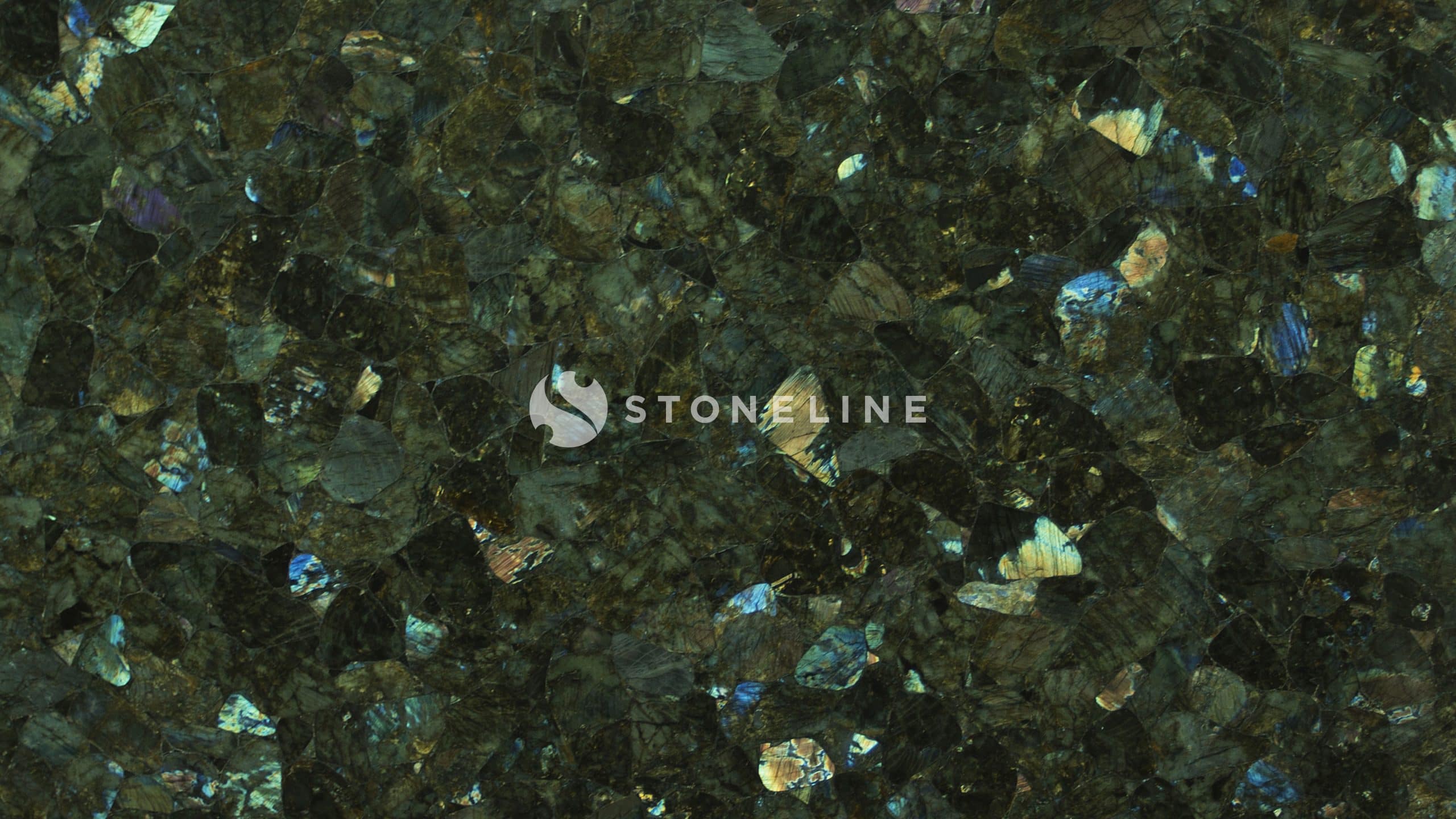 Close-up of dark granite texture with iridescent flecks.