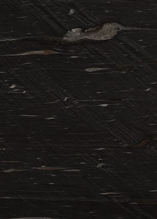 Dark textured stone surface, close-up view.