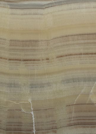 Close-up of beige onyx stone texture and patterns.