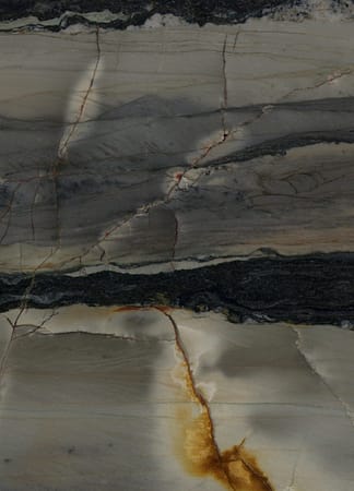 Textured stone slab with dark and light veins.