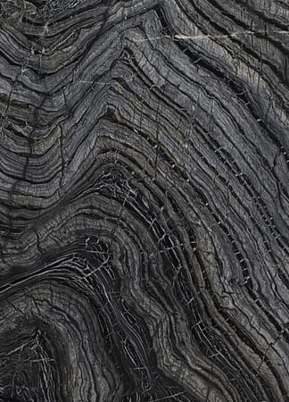 Close-up of swirling black and gray marble pattern.