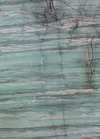 Close-up of marble surface with teal and gray veins.
