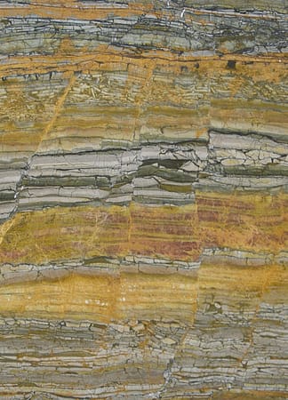 Multicolored natural stone texture with layered patterns
