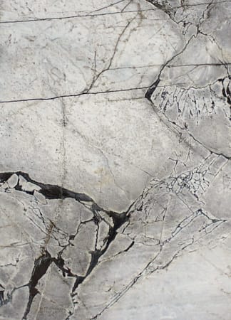 Close-up of cracked, textured gray marble.