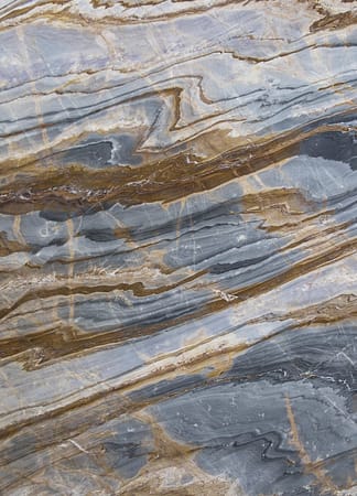 Close-up of polished blue and brown marble texture.