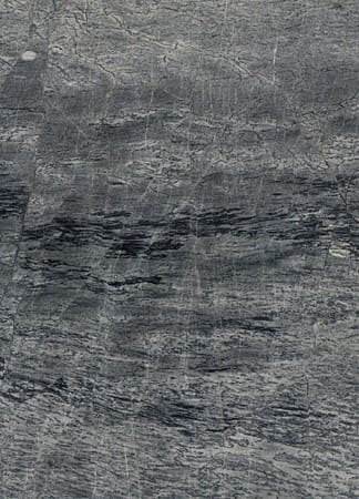 Close-up of textured gray stone surface.
