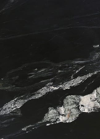 Black marble texture with white veining pattern.