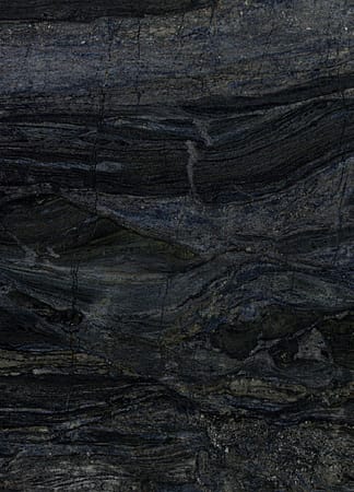 Dark textured stone surface with natural patterns.