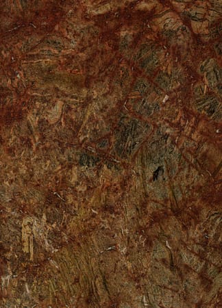 Textured brown and red stone surface background.