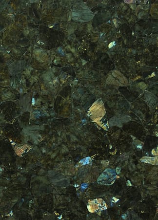 Close-up of dark granite texture with iridescent flecks.