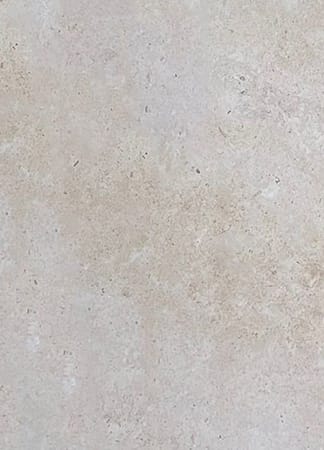 Closeup of light beige textured stone surface.