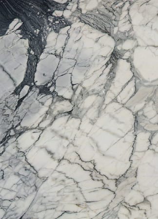 White and gray marble texture with dark veins.
