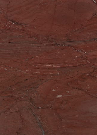 Red marble texture with natural patterns and veins.