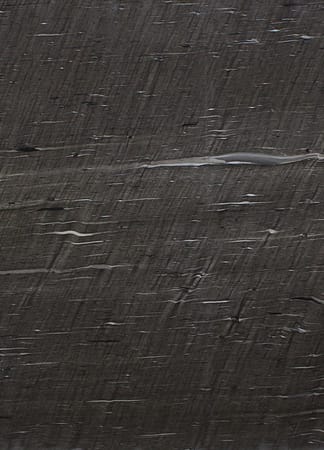 Closeup of dark textured surface.