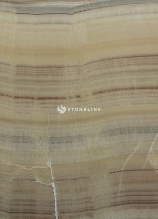 Close-up of beige onyx stone texture and patterns.