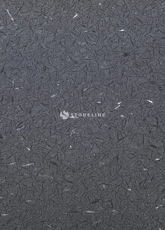 Dark textured surface with scattered gray flecks.