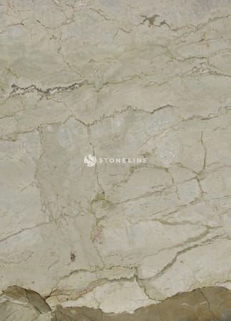 Textured beige marble surface with natural veins.