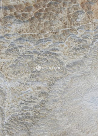 Close-up of natural stone texture with beige patterns.