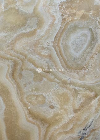 Close-up of beige marble texture with swirls.