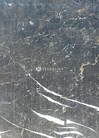 Dark marble surface with white veins.