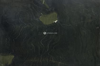Dark textured stone surface with greenish hues.