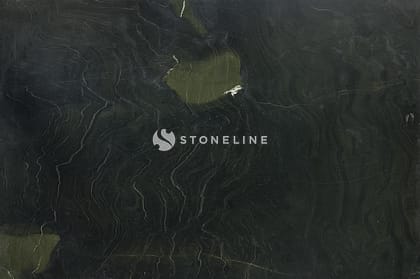 Dark textured stone surface with greenish hues.