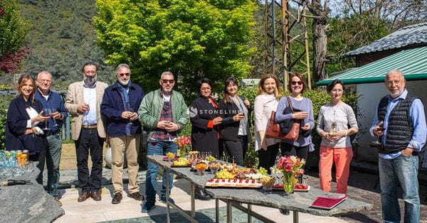 Group enjoying outdoor gathering with food and drinks.
