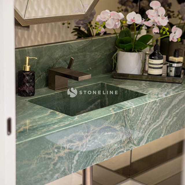 Elegant bathroom sink with green marble countertop.