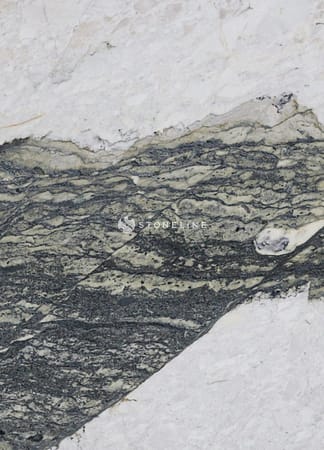 Closeup of marble rock with dark veins.