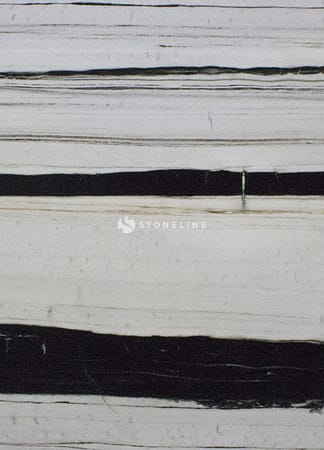 Close-up of black and white striped stone surface.