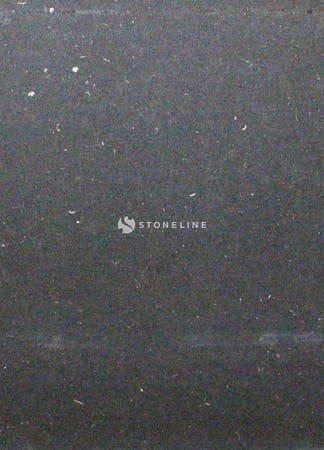 Textured black surface with faint white specks.