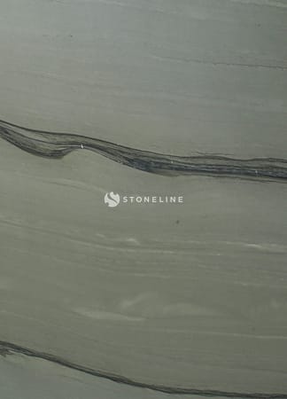 Close-up of gray stone with dark wavy lines.